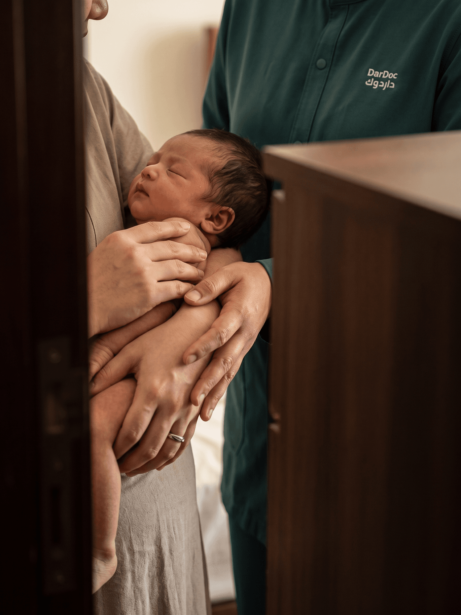 Mother and DarDoc caregiver supporting a newborn